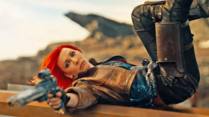 Cate Blanchette in Borderlands, pointing a gun while lying on her back